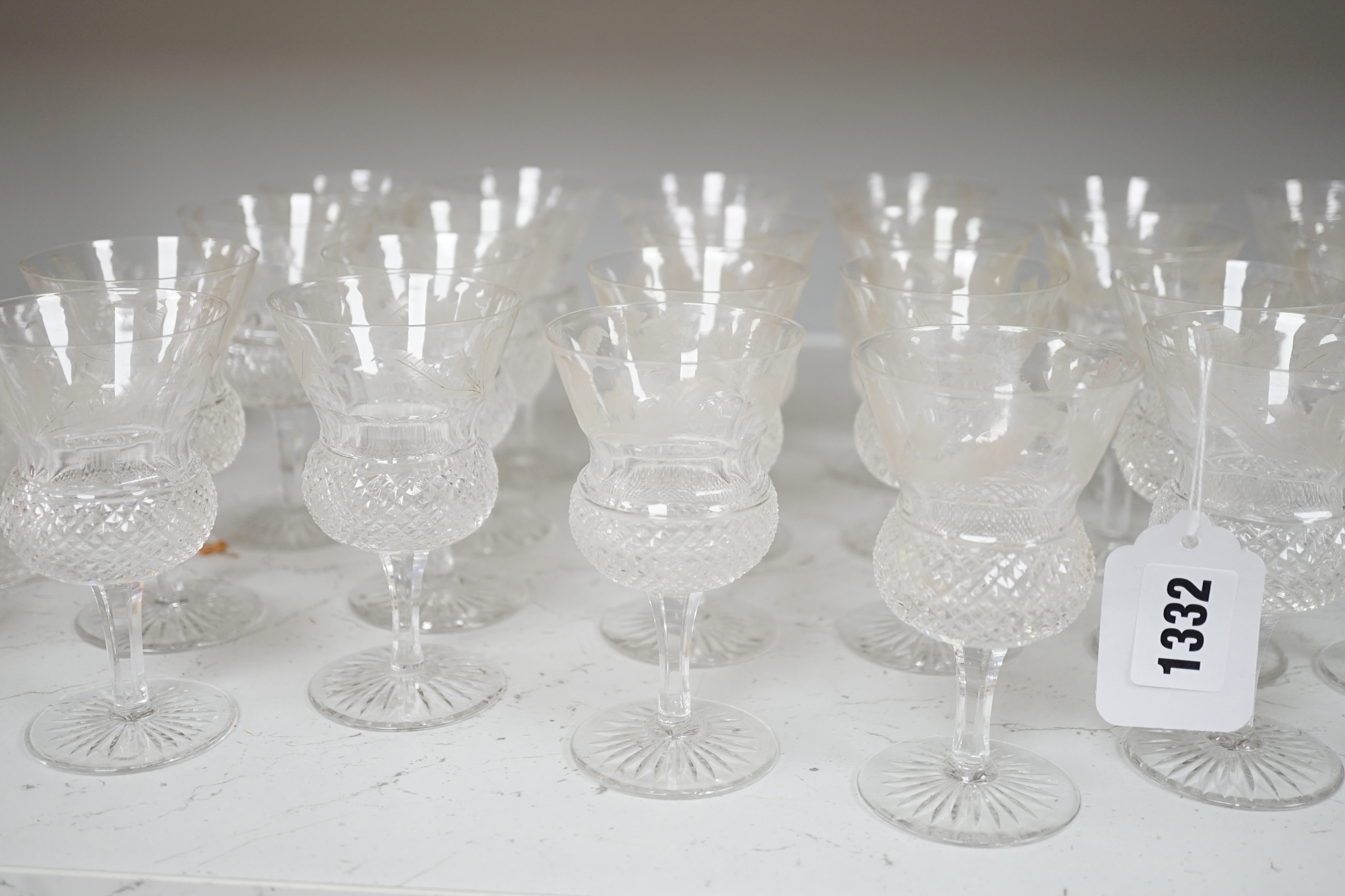A set of twenty four Edinburgh cut glass thistle glasses and thirteen assorted smaller examples, largest 12cm high. Condition - mostly good